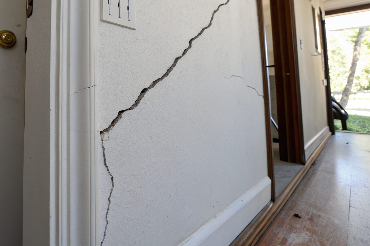 A diagonal drywall crack above a doorframe
